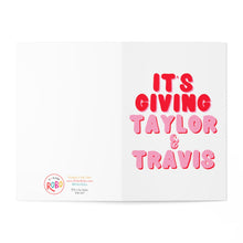 Load image into Gallery viewer, A Valentine's Day card from R is for Robo, titled "Taylor Swift and Travis Valentine's Day Card - Pop Culture Greeting Cards," features bold pink and red text reading "ITS GIVING TAYLOR & TRAVIS" on the right side. On the left side, it has a small logo with the text "Its a Vibe RSDO" along with social media handles. The card is set against a plain white background.