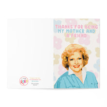 Load image into Gallery viewer, The Betty White Mother's Day Card from R is for Robo, titled "Mothers Day Card for Mom from Daughter - Pop Culture Gifts," showcases a smiling woman in a blue blouse with the text "Thanks for being my mother and a friend" above her. It includes pastel floral patterns, adding to its appeal as an ideal pop culture gift.