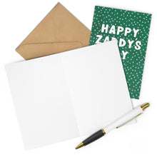 Load image into Gallery viewer, A brown envelope, an open blank white card, and a black-and-white pen are displayed next to the green Happy Zaddy Day card from R is for Robo. Its star pattern design makes it an ideal choice for celebrating with your hot dad in style this Father's Day!