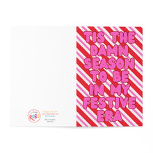 Load image into Gallery viewer, Introducing the "Tis the Damn Season Festive Era Christmas Card" by R is for Robo. This humorous card for Swifties features bold pink text declaring "Tis the damn season to be in my festive era" set against diagonal red and pink stripes. The left side presents a clean white background displaying the R is for Robo logo along with social media handles, making it an ideal holiday choice for any Swiftie ready to celebrate.