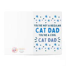 Load image into Gallery viewer, Open greeting card titled "Cat Dad From The Cat - Funny Father's Day Card" by R is for Robo features the text: "You're not a regular cat dad, you're a cool cat dad" in blue. The greeting is highlighted with small blue stars and includes the brand's logo and website details in the corner.