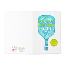 Load image into Gallery viewer, The Pickleball Birthday Card by R is for Robo showcases a vibrant illustration of a blue paddle with the message “It's your birthday, have a ball” on it. Accompanied by a yellow pickleball on the right side, this card features a white background and includes the brand's logo in the bottom left corner, making it an excellent choice for humorous pickleball gifts.
