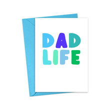 Load image into Gallery viewer, Introducing the Dad Life Funny Father's Day Card for Dad by R is for Robo, showcasing "DAD LIFE" in bold, vibrant colors on a crisp white background. It's ideal for adding your personal touch with a handwritten message and comes paired with an elegant blue envelope.