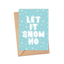 Load image into Gallery viewer, Introducing the Let it Snow Ho Sassy Christmas Card by R is for Robo: This cheeky card showcases the phrase LET IT SNOW HO prominently in bold white letters against a light blue backdrop adorned with delicate snowflakes. Paired with a classic brown envelope, it's an ideal choice for injecting humor into your holiday greetings.