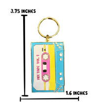 Load image into Gallery viewer, Embrace retro flair with this Cassette Tape Keychain from R is for Robo, designed to resemble a Mix Tape Vol. 1. This enamel keychain showcases a vintage charm with its blue and pink color scheme and includes dimensions of 3.75 inches tall by 1.6 inches wide. The gold keyring attached at the top completes this nostalgic accessory, perfect for any collection.