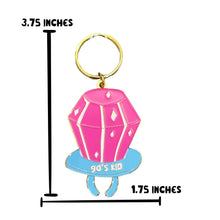 Load image into Gallery viewer, The 90s Kid Ring Pop Keychain from R is for Robo, shaped like a pink gem on a blue oval base and adorned with the words "90s Kid," captures the nostalgic essence of a 90s ring pop. The gem includes white accents, while its retro charm is completed by a gold-colored keyring. It measures 3.75 inches tall and 1.75 inches wide.