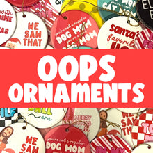 Load image into Gallery viewer, R is for Robo offers a selection of colorful Christmas ornaments under the name "Oops Seconds Christmas Ornaments - Slightly Imperfect Holiday Ornaments." These ceramic, circular ornaments feature humorous text like "We Saw That" and "Dog Mom," along with festive designs showcasing cats, dogs, and other holiday themes. A bold red banner in the center proudly displays "OOPS ORNAMENTS.