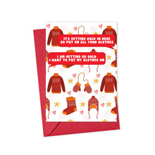 Load image into Gallery viewer, A red envelope contains the Nelly Funny Christmas Card by R is for Robo, adorned with winter clothing items such as sweaters, mittens, a hat, and socks. Cozy messages about staying warm during the holiday season are surrounded by small hearts and stars, bringing smiles in the chill.