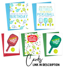 Load image into Gallery viewer, The "In my Pickleball Era" collection from R is for Robo offers five pickleball-themed greeting cards: one for a birthday and four for Christmas, adorned with paddles and balls. These charming gifts include colored envelopes and a Cards Link in Description, making them ideal as holiday decor or a delightful pair with the "In my Pickleball Era" Pickleball Christmas Ornament.
