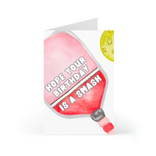 Load image into Gallery viewer, Introducing the Pickleball Birthday Card, designed by R is for Robo! This humorous card showcases a whimsical watercolor illustration of a red pickleball paddle along with a yellow pickleball. The bold white caption, "Hope your birthday is a smash," makes this the ideal choice for any collection of gifts for pickleball enthusiasts.