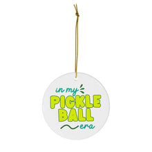 Load image into Gallery viewer, Presenting the "In my Pickleball Era Pickleball Christmas Ornament" by R is for Robo: This charming round white ornament features whimsical green and yellow text stating "in my PICKLEBALL era." Perfect as a pickleball gift, it comes with a thin gold string for easy hanging, making it an excellent addition to your holiday decor.