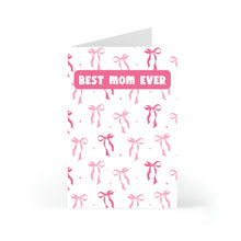 Load image into Gallery viewer, The Cute Coquette Pink Bow Mothers Day Card by R is for Robo stands upright with Best Mom Ever in bold pink letters. It features a pattern of pink bows on a white background, ideal for celebrating the mom and best friend you cherish.