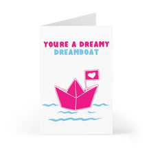 Load image into Gallery viewer, The Dream Boat Funny and Cute Valentine's Day Card by R is for Robo features a charming illustration of a pink paper boat with a heart flag sailing on blue waves. A hand-written note above states "YOU'RE A DREAMY DREAM BOAT" in delightful pink and blue letters, capturing the spirit of love and admiration perfectly.