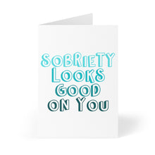 Load image into Gallery viewer, A turquoise Sobriety Soberversary Congratulations Card by R is for Robo showcases bold, colorful lettering with the message "Sobriety Looks Good On You.