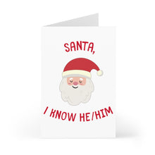 Load image into Gallery viewer, Introducing the "Santa I Know He / Him LGBTQ Christmas Card" by R is for Robo. This festive greeting card features a cheerful Santa Claus wearing a red hat, with the whimsical text "Santa" above him and "I know he/him" below. With its striking red envelope, this card is perfect for adding a vibrant touch to your holiday celebrations against the plain white background.