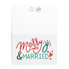 Load image into Gallery viewer, The Merry and Married Christmas Card by R is for Robo showcases playful red and green letters with a ring illustration surrounded by small decorative hearts, making it ideal for sending a handwritten note to your loved ones.