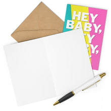 Load image into Gallery viewer, An open heavyweight matte card with a white interior is displayed next to its brown envelope. This colorful and humorous new baby card, titled "Hey Baby Funny New Baby Card" from R is for Robo, features "HEY BABY" in large letters. Accompanied by a black and gold pen perfect for your handwritten note, it makes an appealing presentation.