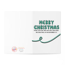 Load image into Gallery viewer, The November 1st Funny Christmas Card by R is for Robo showcases "Merry Christmas" in green bubble letters, accompanied by a playful message: From your girl who has her Christmas decorations up on November 1st. This joyful card also features a green wavy line and the brand's logo in the bottom left corner, delivering holiday cheer to all.