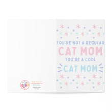 Load image into Gallery viewer, An open greeting card with pastel-colored text reads: "You're not a regular cat mom, you're a cool cat mom," surrounded by blue and pink stars and dots. This humorous Cat Mom Mother's Day Card from the Cat by R is for Robo includes a circular logo with "RoRo" at the bottom left.