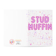 Load image into Gallery viewer, The Stud Muffin Funny Valentine's Day Card by R is for Robo features the phrase STUD MUFFIN in bold pink letters, centered on a white background adorned with pink and purple splatter patterns. The bottom left corner contains contact and copyright details, making it ideal for adding a personal hand-written note to your stud muffin.