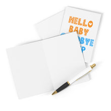 Load image into Gallery viewer, A blank open card with a black and gold pen rests beside a folded baby card from R is for Robo, decorated with "Hello Baby" and "Goodbye Sleepy" in colorful lettering, alongside a kraft envelope waiting for your heartfelt handwritten note.