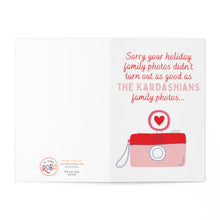 Load image into Gallery viewer, Funny Pop Culture Christmas Card for Her featuring a red camera illustration and heart icon. The text says: Sorry your holiday family photos didn't turn out as good as the Kardashians... Printed on heavyweight matte, this card is branded with R is for Robo at the bottom left.