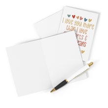 Load image into Gallery viewer, A blank I Love You card with a gold and black pen rests beside the Side Part and Skinny Jeans I Love You Card by R is for Robo, which reads, "I love you more than I love charts & diagrams," adorned with colorful heart illustrations—ideal for adding a personal touch that complements your side part and skinny jeans style.