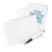 Load image into Gallery viewer, A blank greeting card and envelope are paired with a sleek black and gold pen, perfect for your personal touch. Nearby, the R is for Robo Damn Thang Funny Congratulations Card exclaims "You did the damn thing" in bold blue text set against a playful polka dot background.