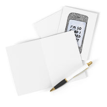 Load image into Gallery viewer, Two blank greeting cards with white envelopes are displayed. One card, ideal for celebrating an online dating anniversary, is the "Tinder Online Dating Anniversary Card" by R is for Robo, featuring a smartphone design with the text "I'm so glad I swiped right." Beside the heavyweight matte cards lies a black and white pen with a gold tip.