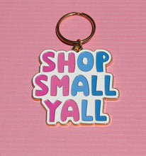 Load image into Gallery viewer, A Shop Small Yall Keychain by R is for Robo, set against a pink background, showcases the message "Shop Small Yall" in vibrant, playful letters, encouraging support for local businesses and community commerce.
