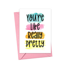 Load image into Gallery viewer, The "You're Like Really Pretty Friendship Card" by R is for Robo is a stunning option, featuring colorful watercolor swashes in blue, pink, orange, and yellow. It includes a pink envelope and bold black text stating "You're Like Really Pretty," making it ideal for expressing heartfelt handwritten notes.