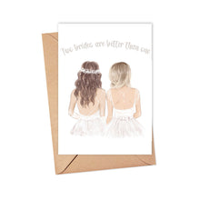 Load image into Gallery viewer, The Two Brides Wedding Card by R is for Robo showcases an illustration of two brides in white dresses—one with long brown hair adorned with a flower crown, and the other with short blonde hair. The card highlights the joyful message that "Two brides are better than one." It includes a brown envelope and is printed on heavyweight matte card.
