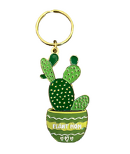 Load image into Gallery viewer, This adorable Plant Mom Keychain - Cactus Succulent Keychain from R is for Robo features a vibrant green cactus with small yellow spots, set in a beautifully patterned pot marked with "Plant Mom" and accented by two hearts. Made from cactus gold enamel, this charming accessory comes with a gold-colored keyring, perfect for celebrating plant parenthood in style.