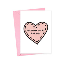 Load image into Gallery viewer, The "Everyone Sucks But You" funny anniversary card by R is for Robo showcases a heavyweight matte design with a pink heart illustration and the bold black text conveying the humorous message. It comes with a pink envelope and is ideal for printing at home.