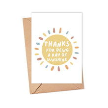 Load image into Gallery viewer, The Ray of Sunshine Thank You Card by R is for Robo showcases a vibrant yellow sun design alongside the heartfelt message, "Thanks for being a ray of sunshine." Set against a crisp white background, this card comes with a charming brown envelope, making it perfect for conveying warmth and gratitude in a handwritten note.