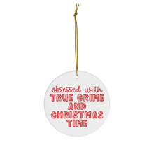 Load image into Gallery viewer, A round, white ceramic ornament from R is for Robo is suspended by a gold string and features red text that says, "Obsessed with true crime and Christmas time." This True Crime Funny Christmas Ornament is ideal for the true crime enthusiast in your life.