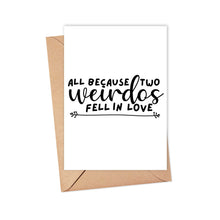 Load image into Gallery viewer, The "Two Weirdos Funny Wedding Card" by R is for Robo features the phrase "All because two weirdos fell in love" in black script on a white background, complemented by simple arrow designs, and is paired with a rustic kraft envelope.
