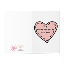 Load image into Gallery viewer, The "Everyone Sucks But You Funny Anniversary Card" by R is for Robo features a pink heart-shaped design on a white background. The inside of the heart humorously states, "Everyone sucks but you." Ideal for those who enjoy a cheeky sentiment, this card can be printed at home on heavyweight matte paper for the best outcome.