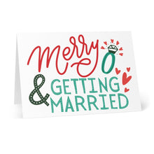 Load image into Gallery viewer, Introducing the Merry & Getting Married Engagement Christmas Card by R is for Robo. This charming card showcases festive "Merry & Getting Married" text in vibrant red and green, accompanied by delightful illustrations of a ring and hearts. Designed to stand upright against a crisp white background, it's perfect for adding your personal, hand-written note to congratulate the happy couple.