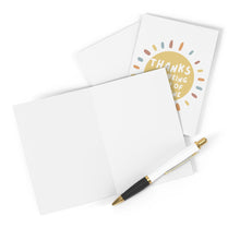 Load image into Gallery viewer, Two Ray of Sunshine Thank You Cards by R is for Robo, each decorated with a hand-written note saying "Thanks for being one of a kind" surrounded by colorful dots, lie open. A gold and black pen is placed in front of them.