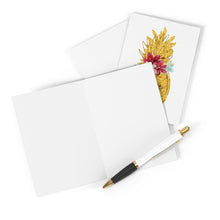 Load image into Gallery viewer, A You are Golden Pineapple Thank You Card or Friendship Card by R is for Robo sits open next to a closed card, both beautifully embellished with a floral design and gold pineapple. A white and gold pen lies beside them, completing the elegant scene set against a pristine white background.
