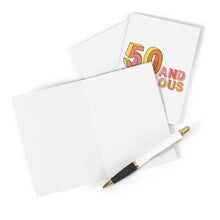 Load image into Gallery viewer, Display the "50th Birthday Card - Funny Milestone Birthday Card for Him or Her" by R is for Robo, showcasing the text "50 and Fabulous" partially visible. The card is accompanied by a black and white pen with gold accents, set against a white surface. It's an ideal choice for adding a personal touch with your handwritten message.