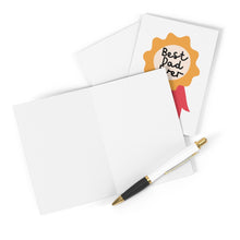 Load image into Gallery viewer, A blank greeting card is open on a white surface, accompanied by a white pen with gold accents. Next to it is a closed "Best Dad Ever" Father's Day card from R is for Robo, featuring the text in a gold badge design.