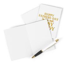 Load image into Gallery viewer, A set from R is for Robo featuring the Baby Daddy Funny Father's Day Card includes one open and blank card, another with a handwritten note saying "Happy Father's Day to the best baby daddy" in gold text, resting beside a black and gold pen on a white surface.