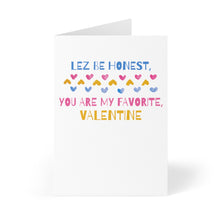 Load image into Gallery viewer, Introducing the "Lez Be Honest Lesbian Valentine's Day Card" by R is for Robo. This vibrant card features the playful phrase "LEZ BE HONEST, YOU ARE MY FAVORITE, VALENTINE" in lively colors, adorned with charming heart shapes in shades of pink, yellow, and blue. It stands gracefully on a crisp white background, offering an ideal space for you to add a personal handwritten message for your special someone.