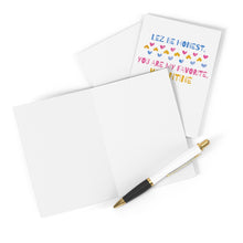 Load image into Gallery viewer, Blank greeting card and envelope alongside a pen next to an open Valentine's card from R is for Robo, titled the "Lez Be Honest Lesbian Valentine's Day Card," featuring colorful text that reads "LEZ BE HONEST, YOU ARE MY FAVORITE VALENTINE" with heart designs—ideal for adding your own heartfelt handwritten note.