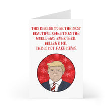 Load image into Gallery viewer, The Donald Trump Christmas Card Funny by R is for Robo features a humorous illustration of a blonde-haired person wearing a red tie on a red background. The card includes the text, "This is going to be the most beautiful Christmas the world has ever seen. Believe me. This is not fake news.