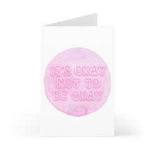 Load image into Gallery viewer, Introducing the "It's Okay Not to Be Okay" Sympathy Card by R is for Robo. Featuring a minimalist design, this card showcases a light pink watercolor circle centered on the cover, with the comforting message "It's okay not to be okay" in white text. The open side view and white background make it ideal for adding your personal handwritten note inside.