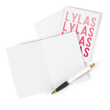 Load image into Gallery viewer, An open blank card with a white envelope and a pen beside it is perfect for crafting a heartfelt handwritten note. In the background, the LYLAS 90s Friendship Card by R is for Robo displays its message in pink letters, capturing the essence of sisterly bonds.