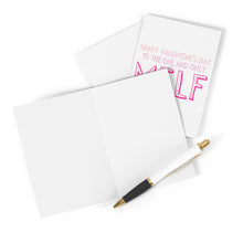Load image into Gallery viewer, A pen is poised on a blank greeting card, inviting your personalized handwritten message. In the background, another card from R is for Robo humorously announces, "Happy Valentine's Day to the one and only MILF" in pink and red, aptly named the MILF Funny Valentine's Day Card for Wife.